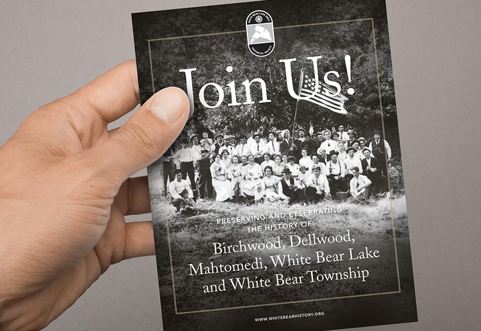 Close up teaser image of hand holding membership brochure, designed by Carolyn Porter of Porterfolio, Inc. for the White Bear Lake Area Historical Society